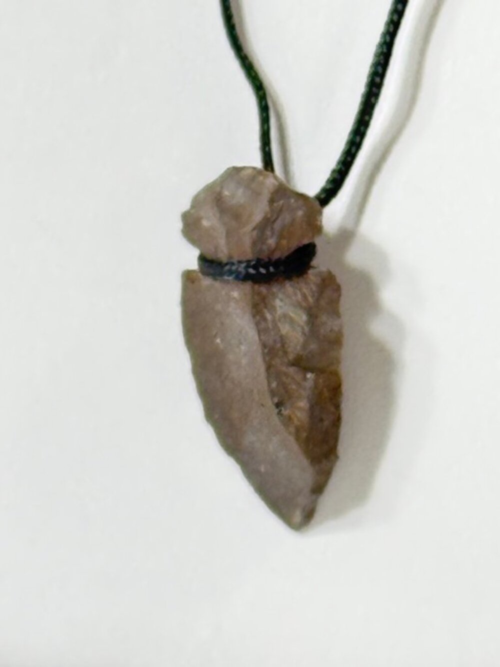 Vintage flint arrowhead and black cord necklace.